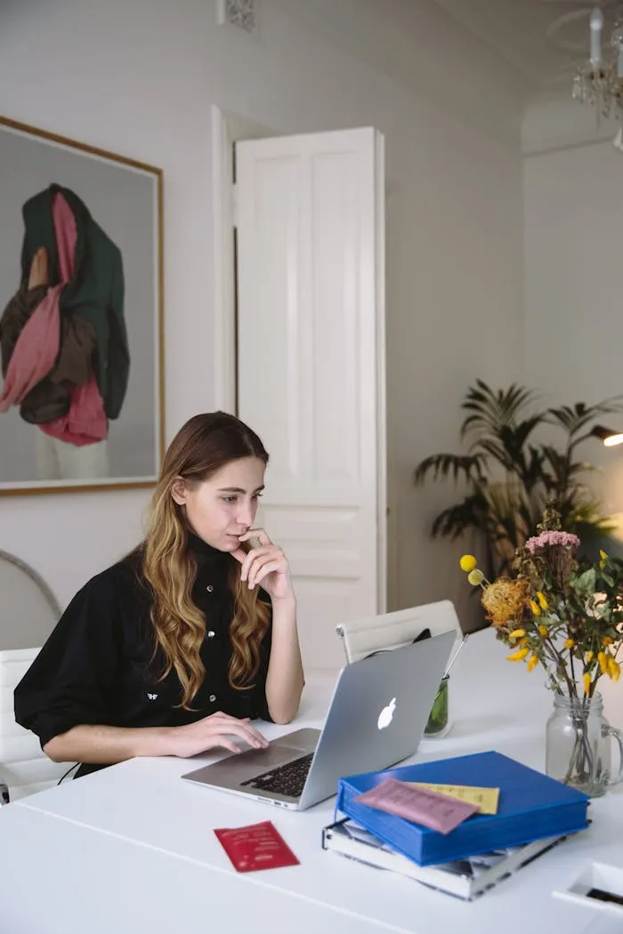 A Mac user pausing mid-decision at a MacBook, weighing which Office version to choose